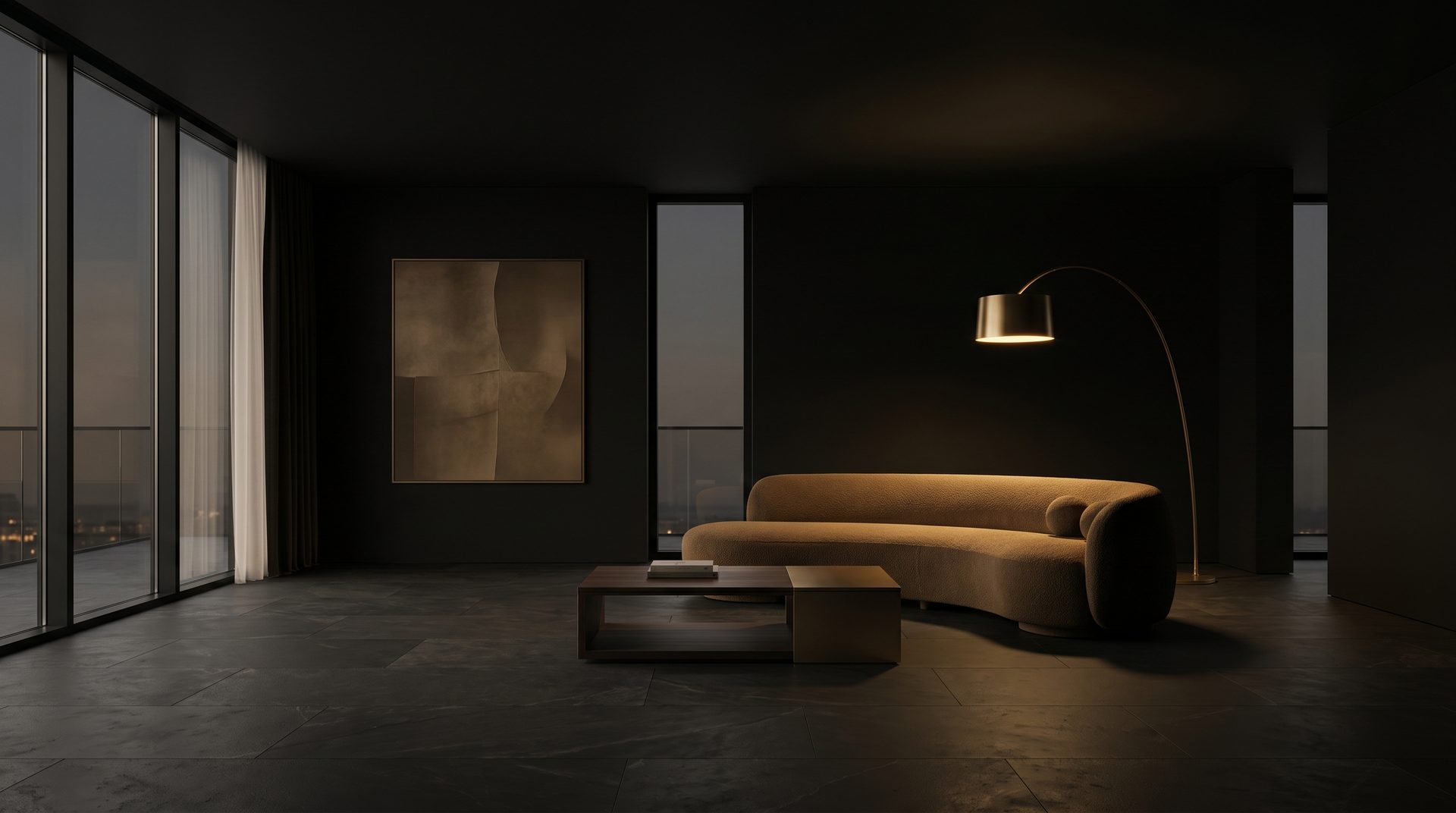 A sculptural curved sofa in a dark luxury living room lit by a warm arc lamp